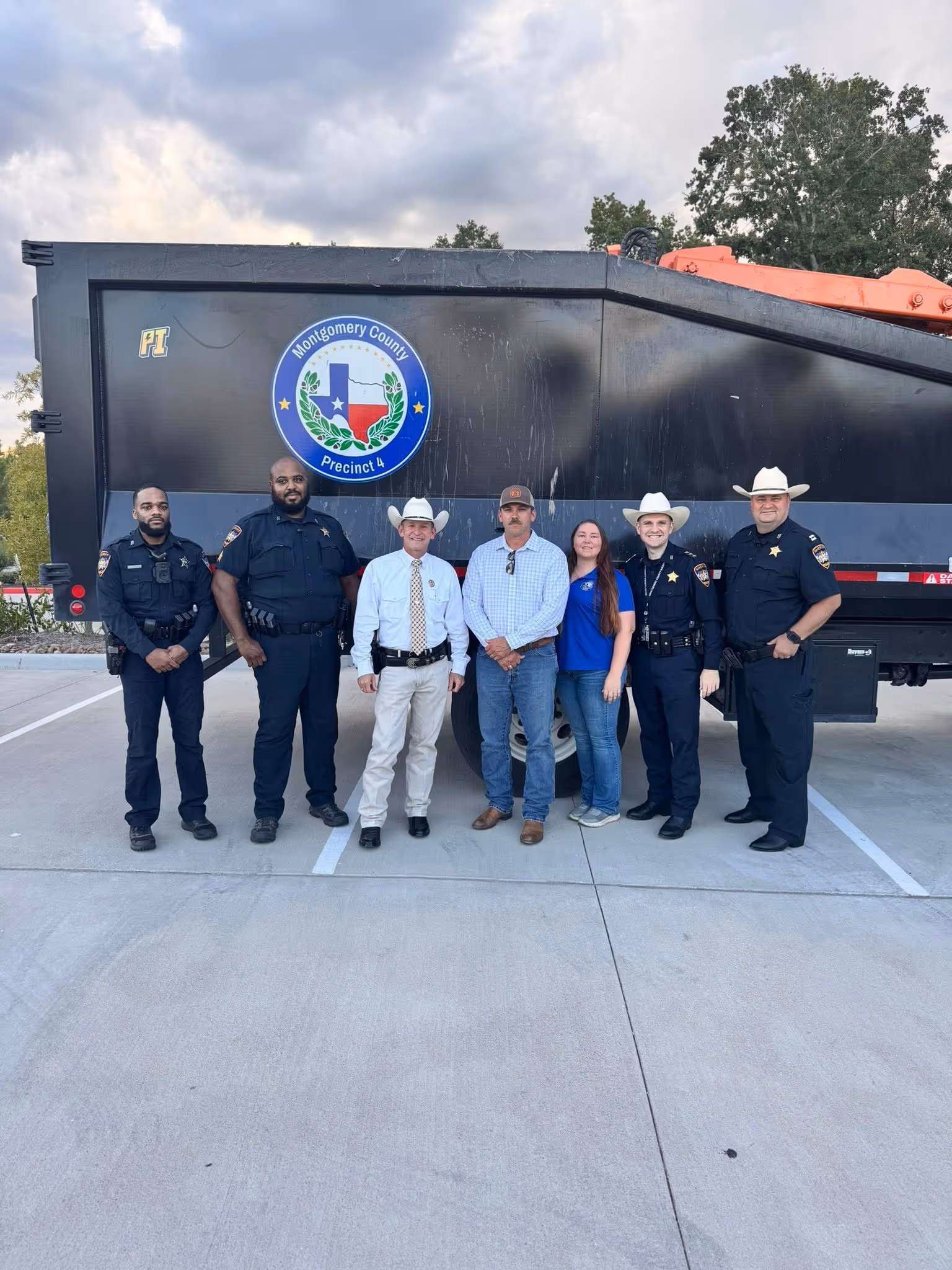 Montgomery County deputies and community members standing together in front of an official county vehicle