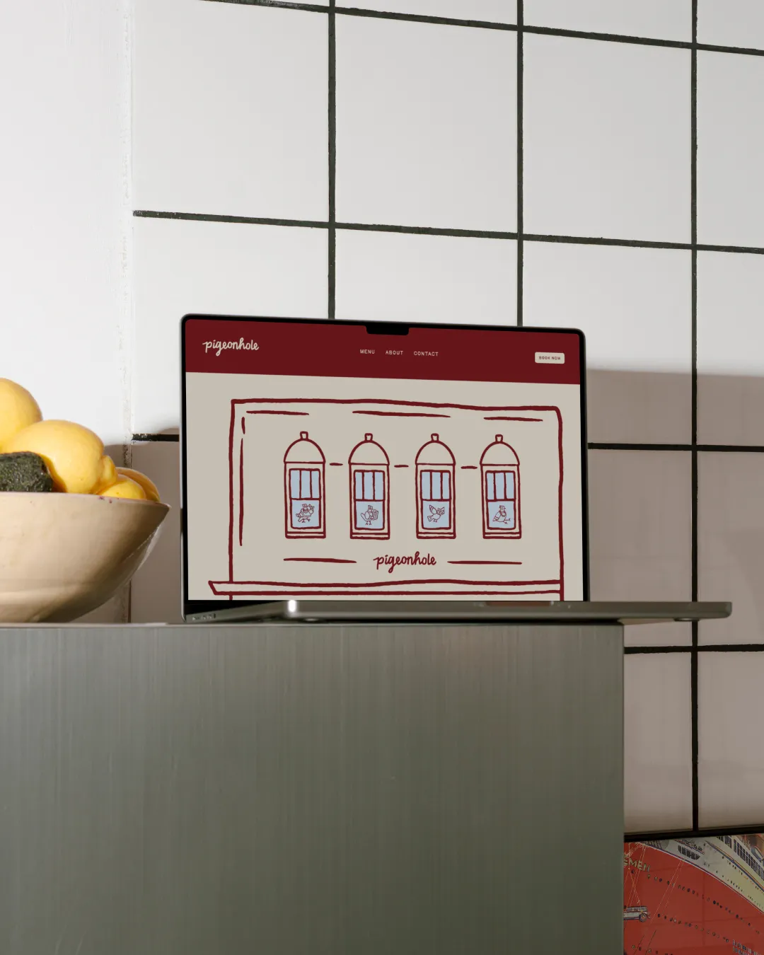 Open brand guideline booklet showing a colour palette with terracotta, blue, off white, black, and white colors, alongside social media design elements including a phone screen mockup and logo.