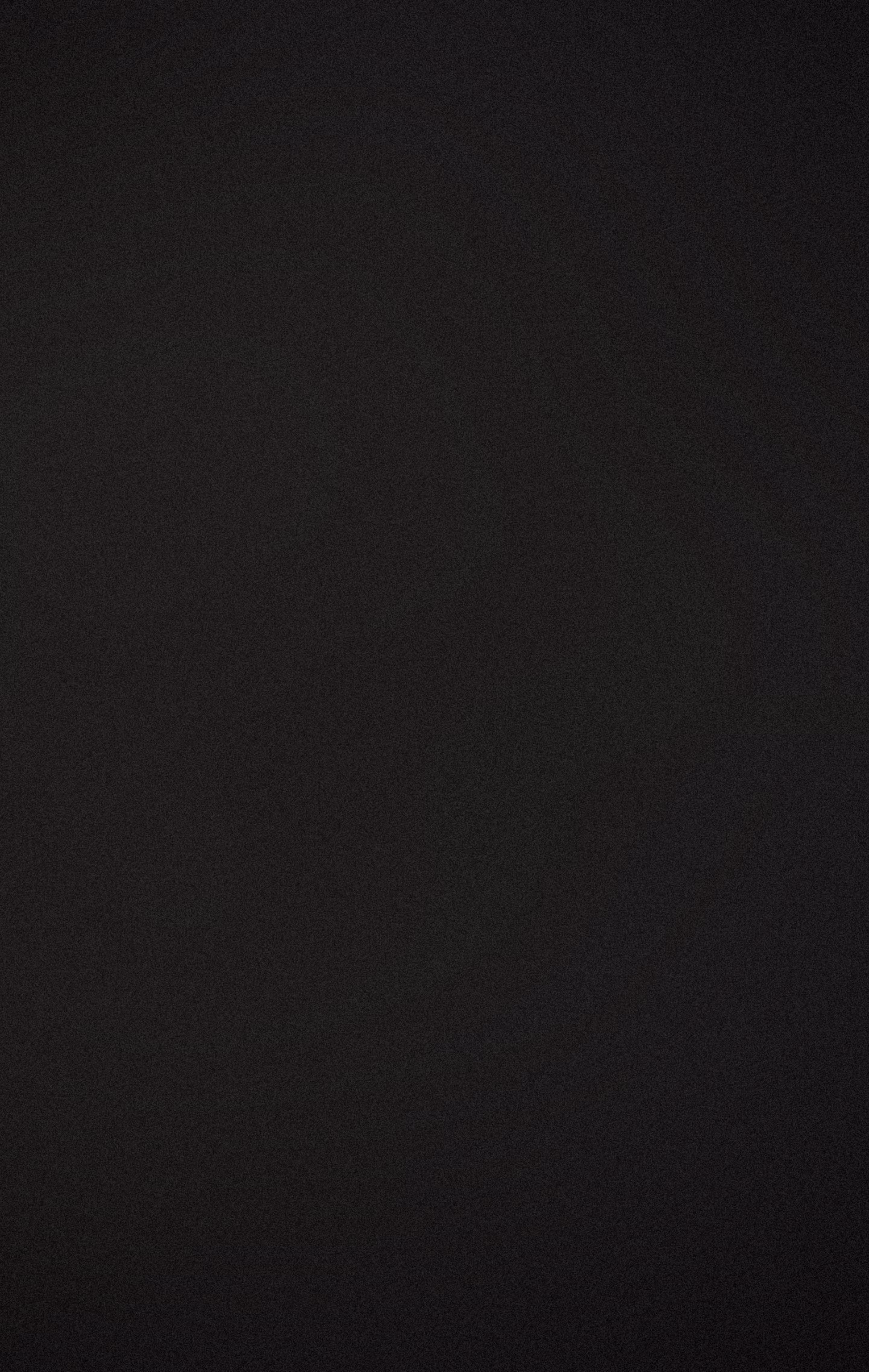 Czarne ziarniste tło z delikatnym gradientem.