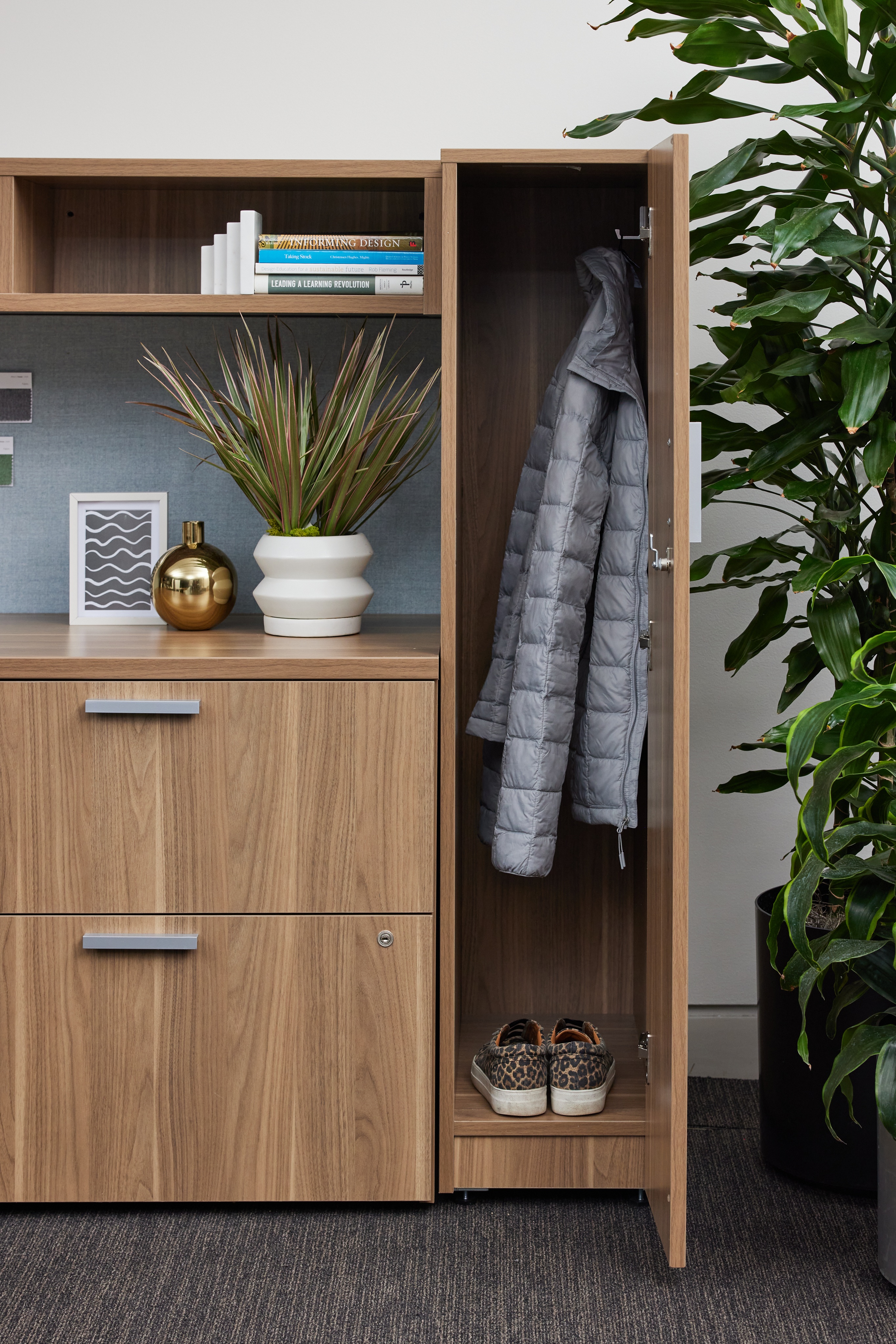 Row of large office multifunction printers or copiers lined up indoors.