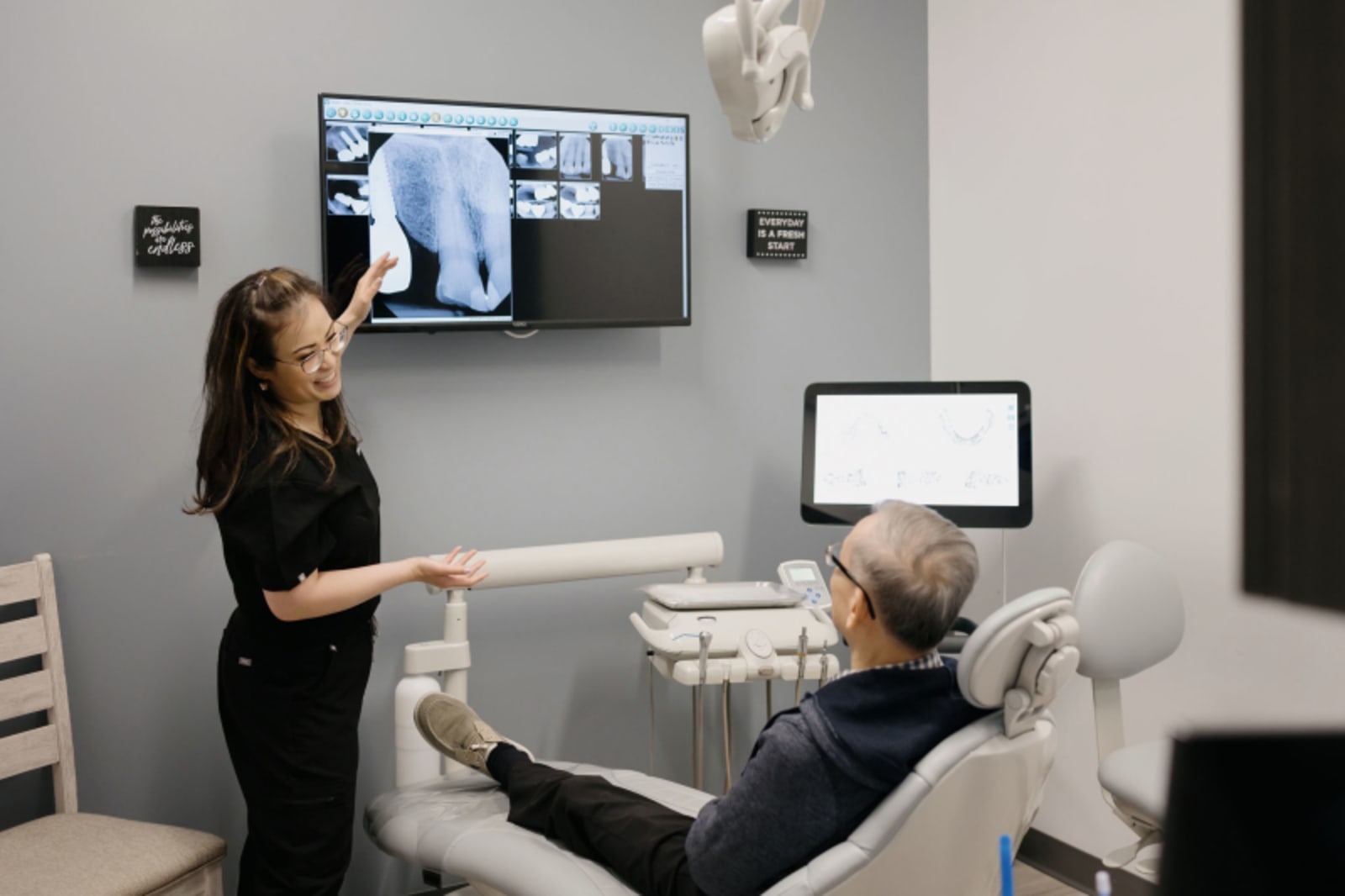 Dentist discussing digital teeth scan with patient during Invisalign consultation