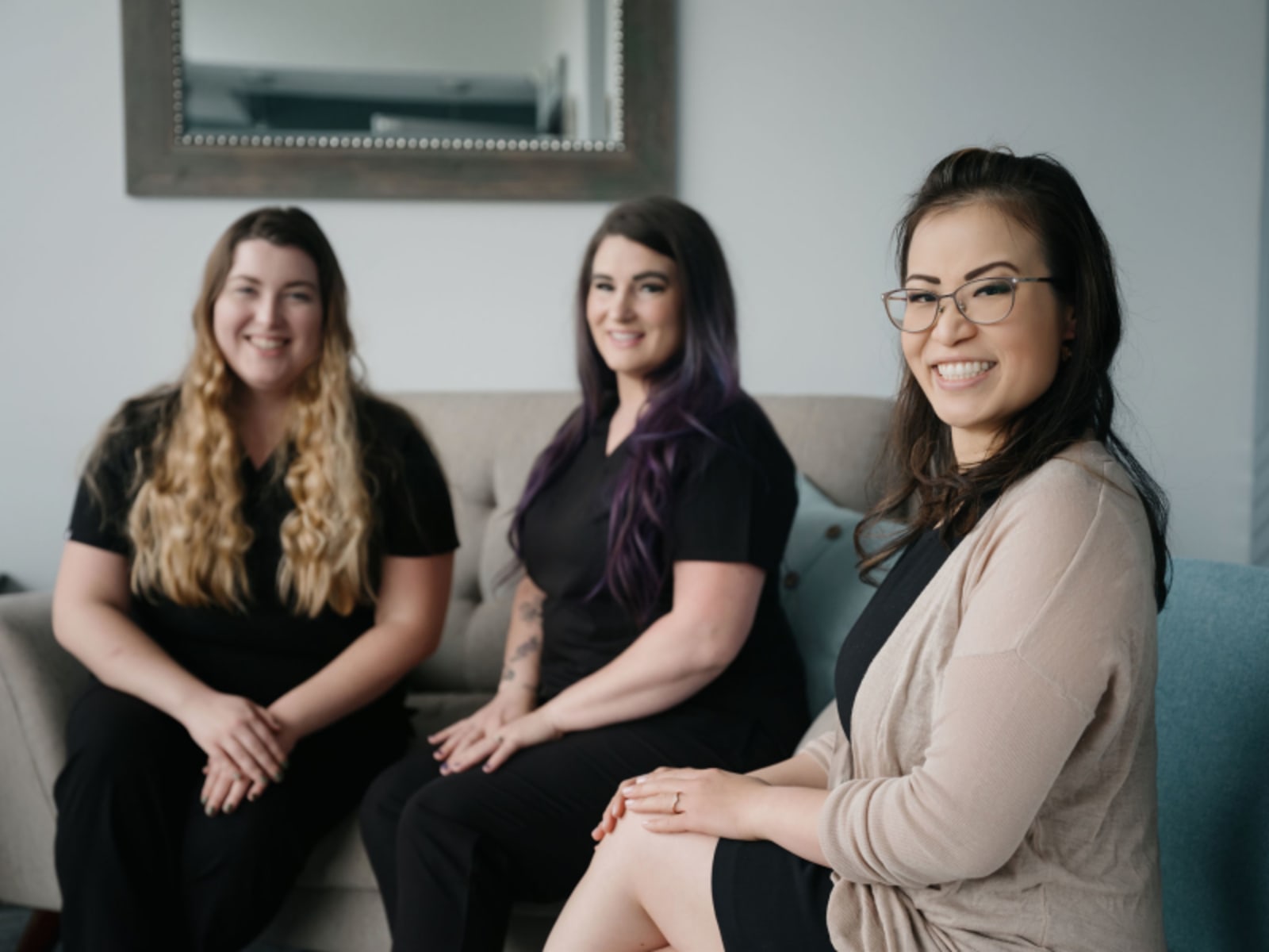 Team of dental professionals at Genuine Smiles smiling together in office