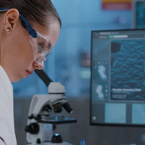 woman at telescope and computer monitor