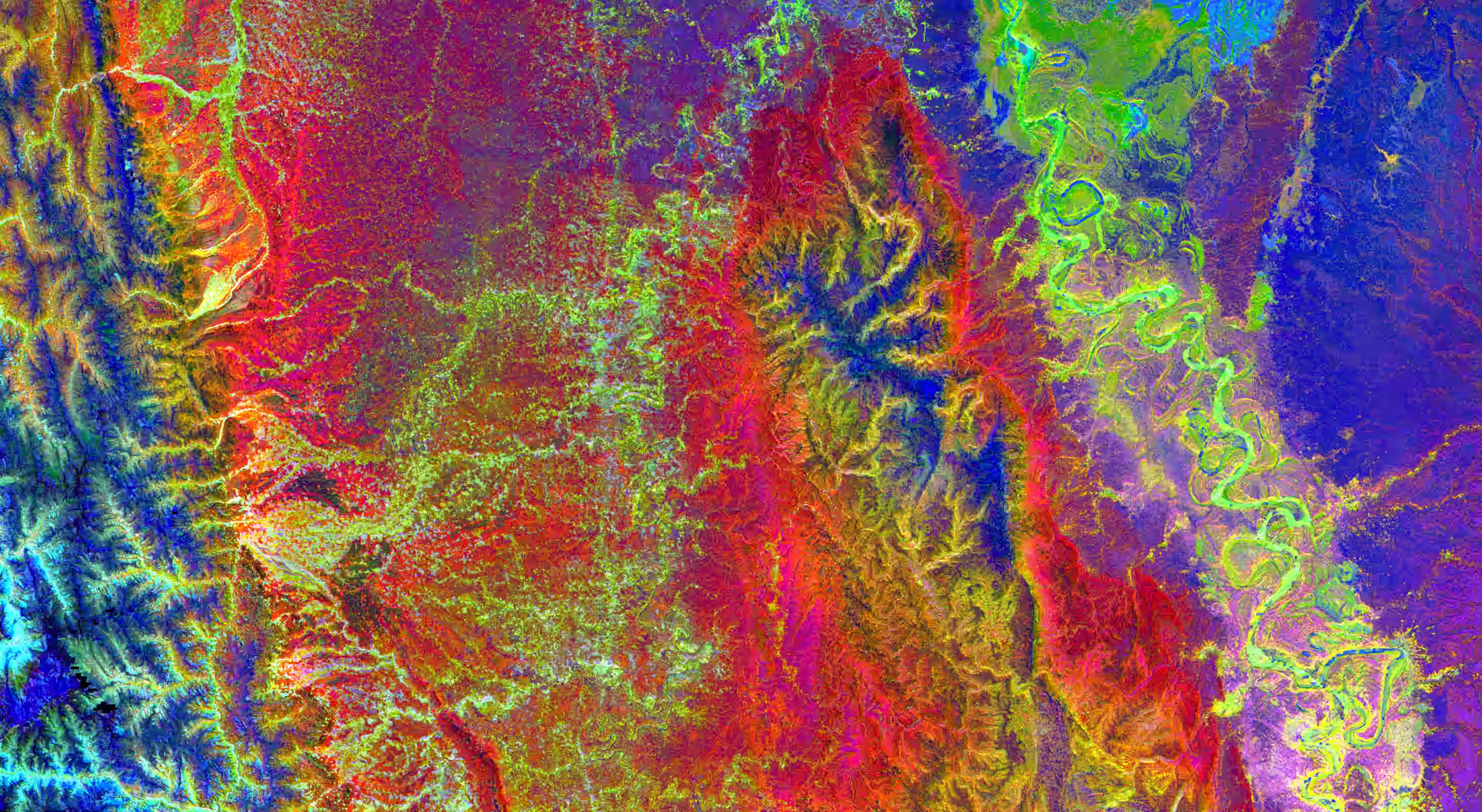 Colorful false-color satellite image showing varied terrain with river bends and mountain ridges.