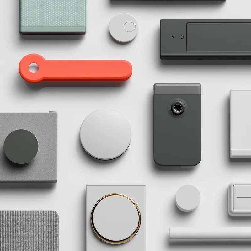 Flat lay of modern UI-inspired objects in neutral tones with orange accent.