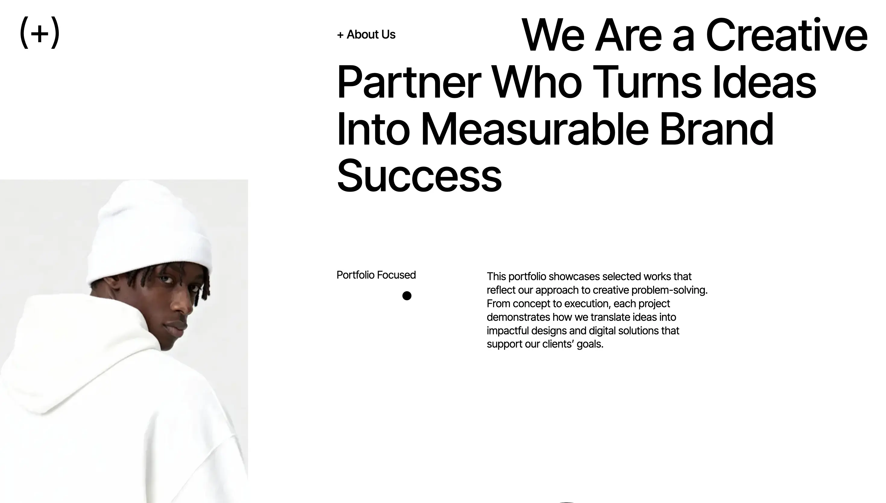 Website section with text 'We Are a Creative Partner Who Turns Ideas Into Measurable Brand Success' and a photo of a young man in a white hoodie and white beanie looking over his shoulder.