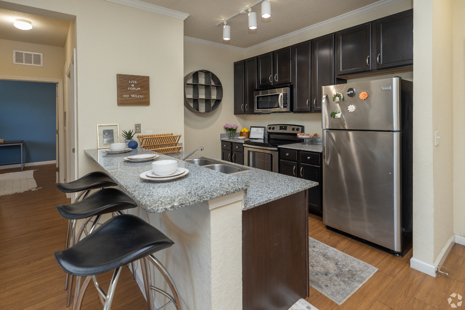 kitchen with stainless steel appliances and breakfast bar with chairs 