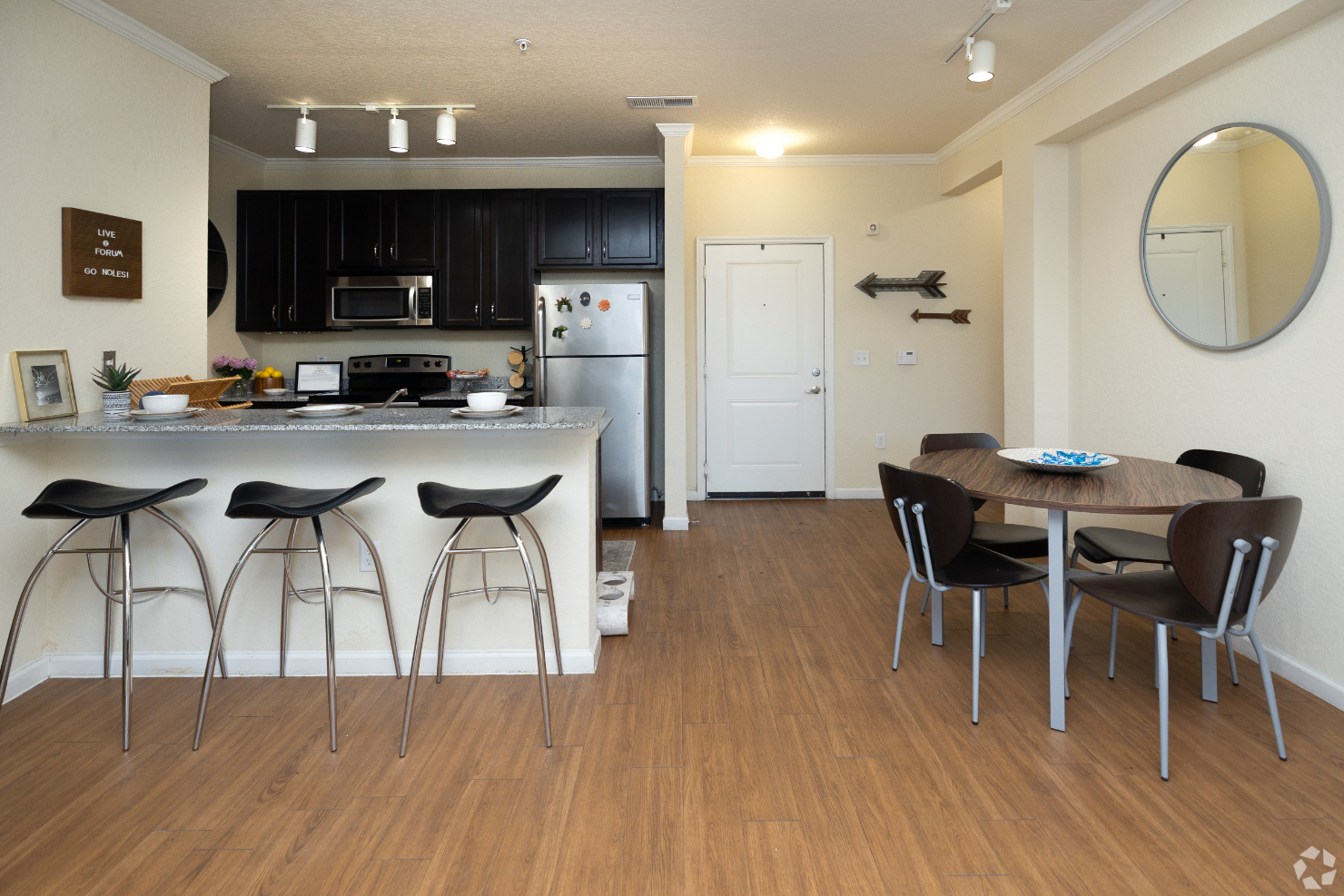 kitchen with view of dining area with table and chairs and breakfast bar with chair