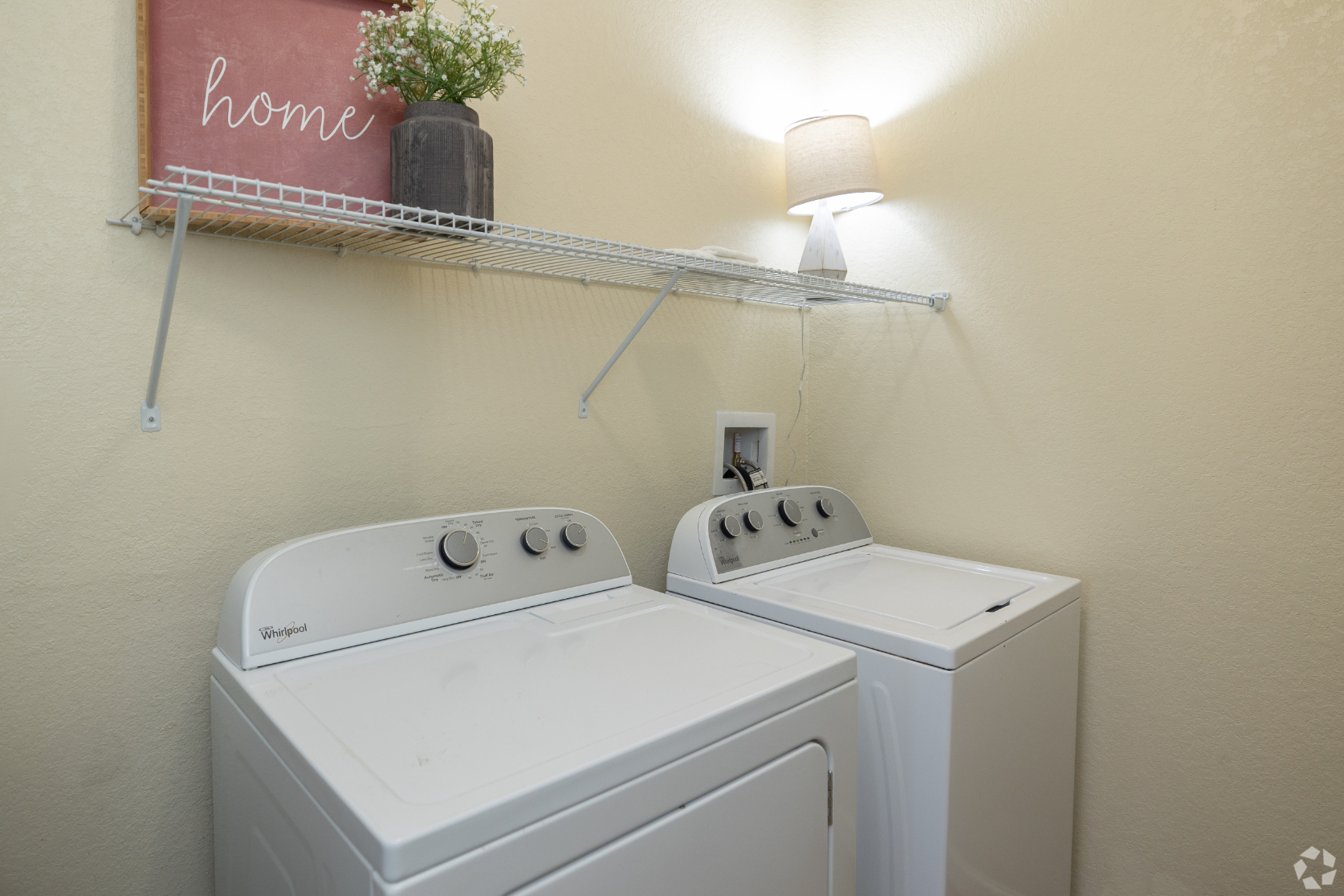 laundry room with washing and drying machines in white
