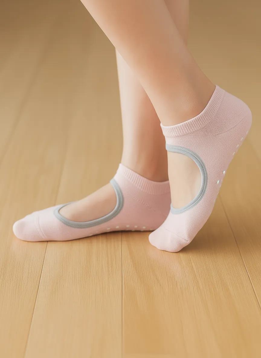 Close-up of a woman wearing light pink non-slip Pilates grip socks on a wooden floor. Ideal for Pilates Reformer workouts, yoga, barre, and home training — designed to provide stability, comfort, and style during exercise.