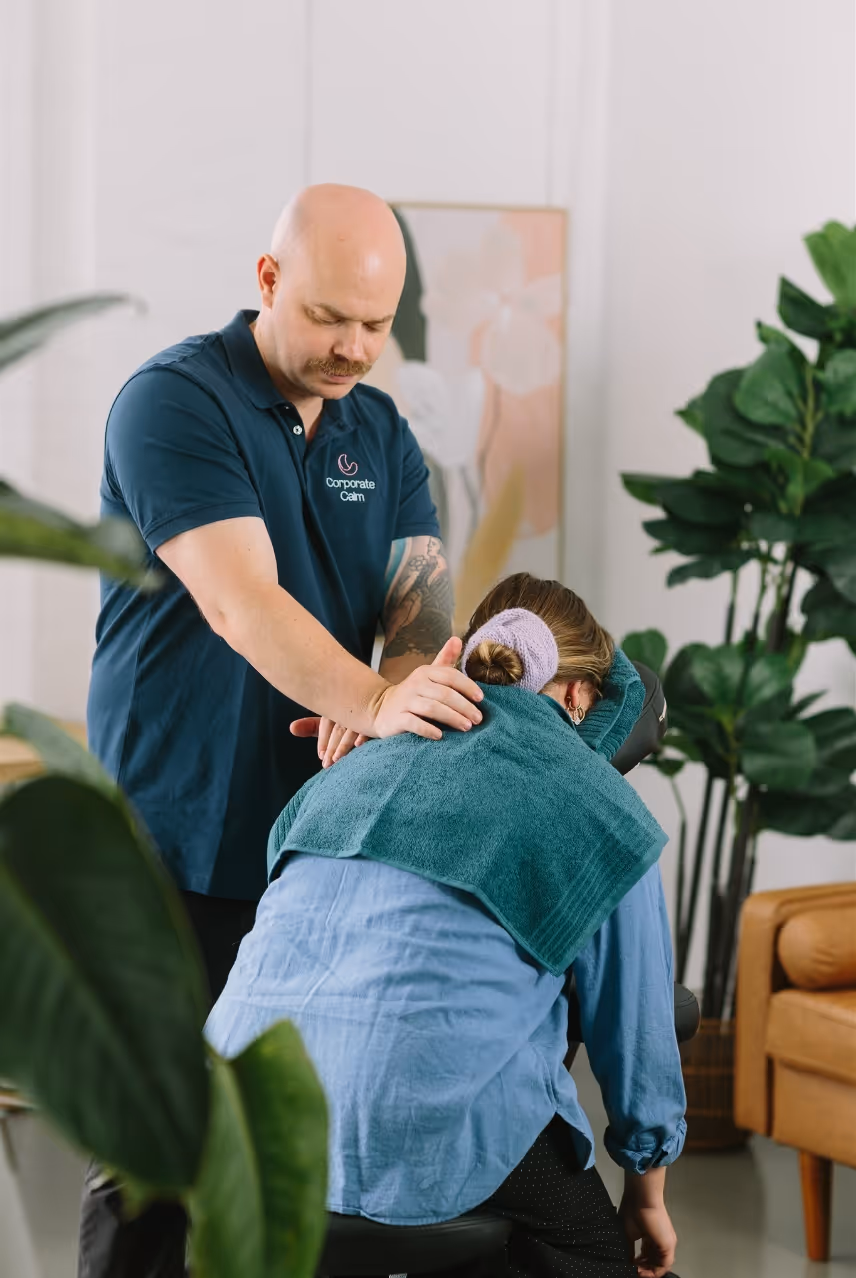 Employee receiving a 15-minute workplace massage session at their office