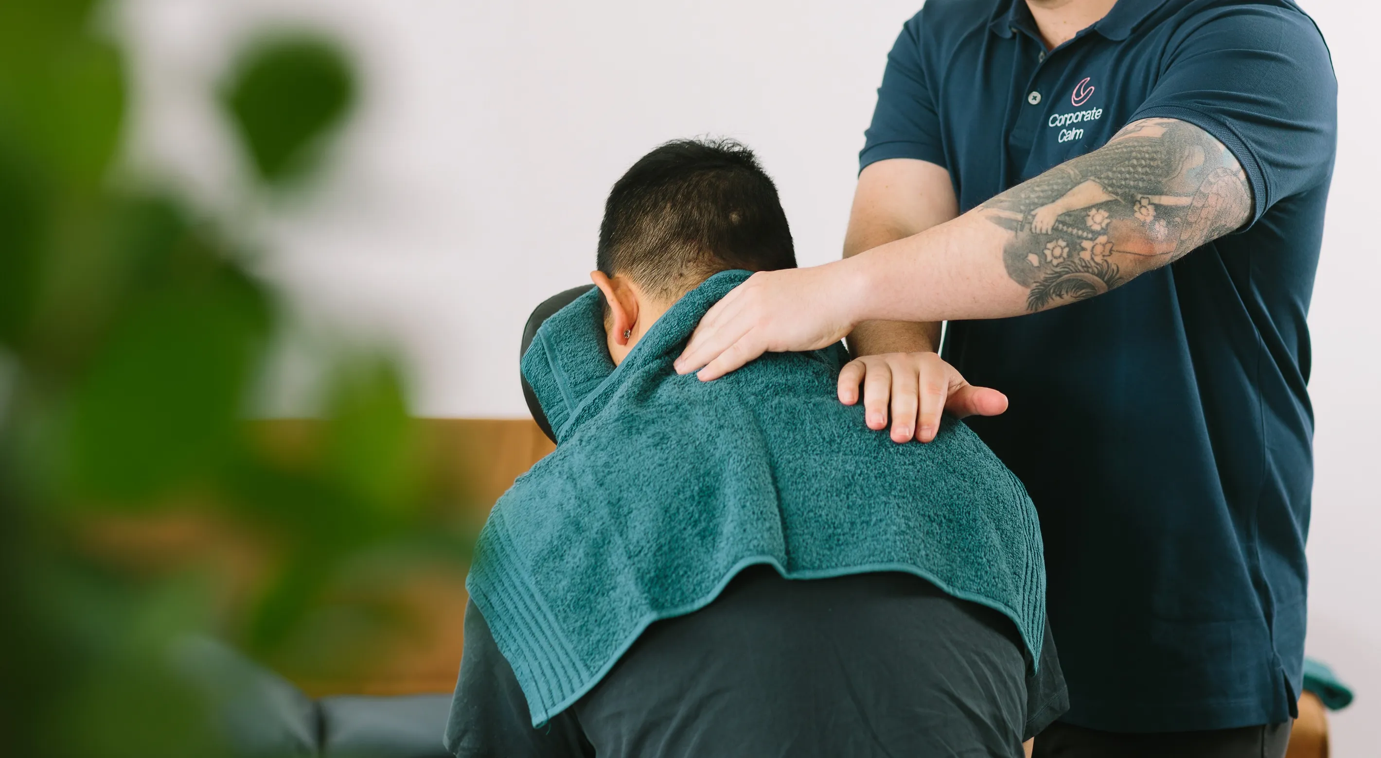 Corporate Calm therapist delivering workplace massage to a call centre agent
