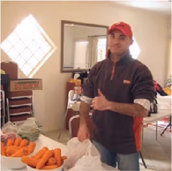 Man in red cap with a thumbs up