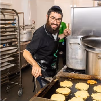 C Care staff member cooking in the kitchen