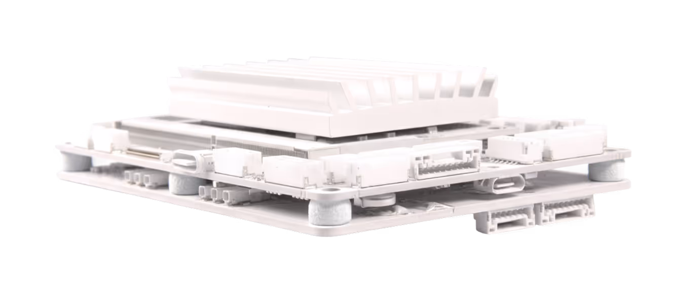 White compact electronic circuit board with connectors and a large heat sink on top.