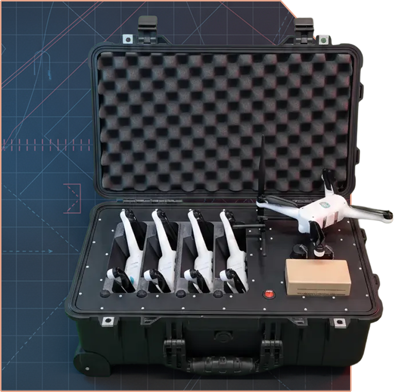 Black hard case with foam padding containing four white handheld devices with rotors and one drone alongside a small cardboard box.