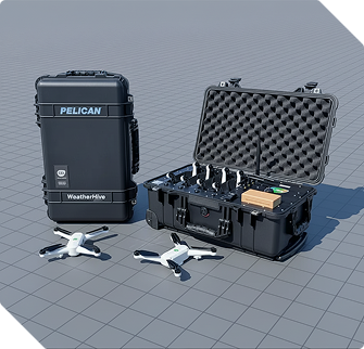 Black Pelican WeatherHive case with an open compartment showing electronic equipment and two white drones on a gray tiled surface.