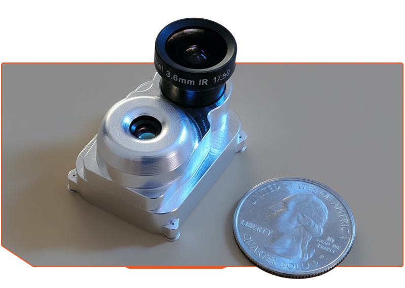 Small metal camera module labeled Pixel 3.6mm IR next to a US quarter coin for size comparison.