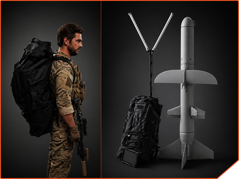 Soldier in camouflage uniform carrying a large black backpack and rifle stands beside a large drone and equipment bag with antennas and tablet on a dark background.