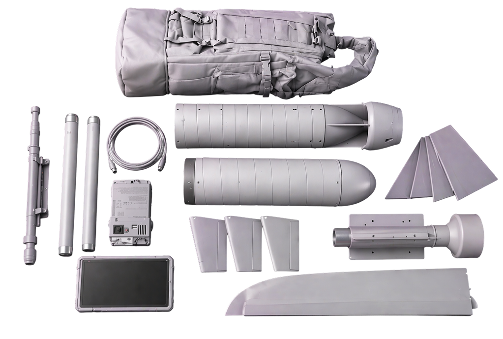 Disassembled parts of a gray drone including fuselage, wings, tail fins, propeller, control unit, cable, and carrying bag.