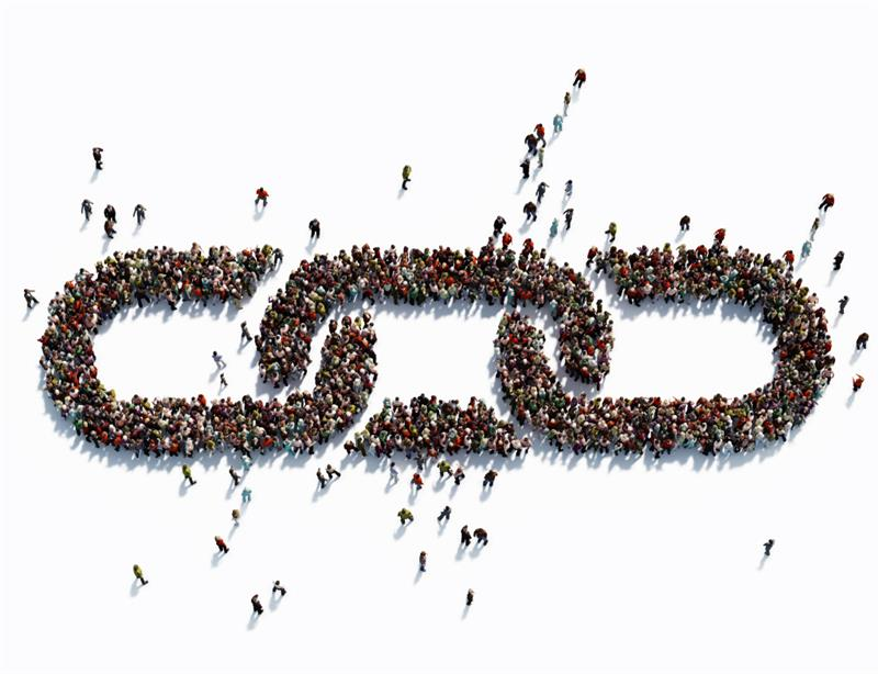 Top-down view of many people arranged to form a broken chain link on a white background.