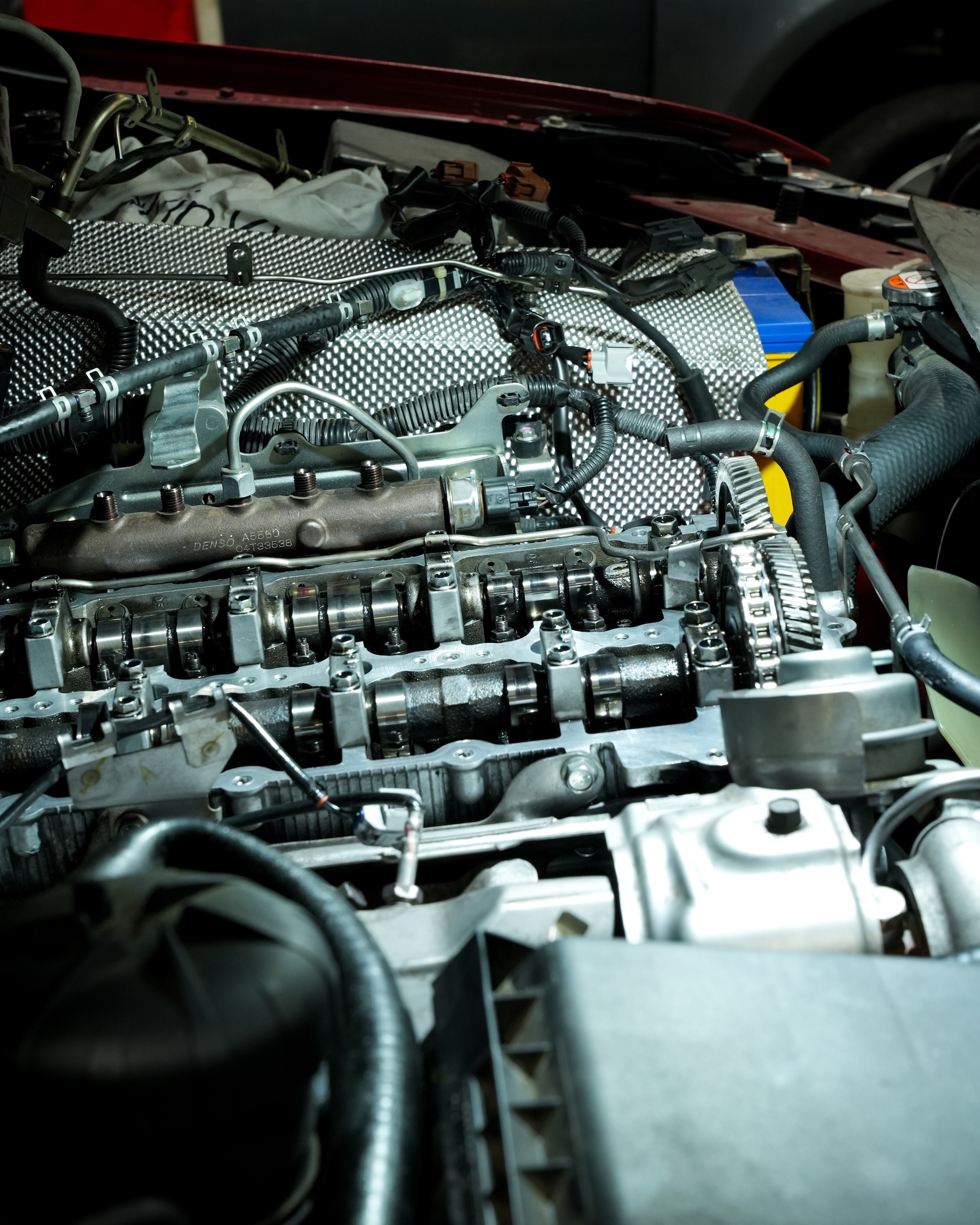 Pearson Automotive mechanic performing a car battery health check and alternator test on a vehicle in the Milton workshop.