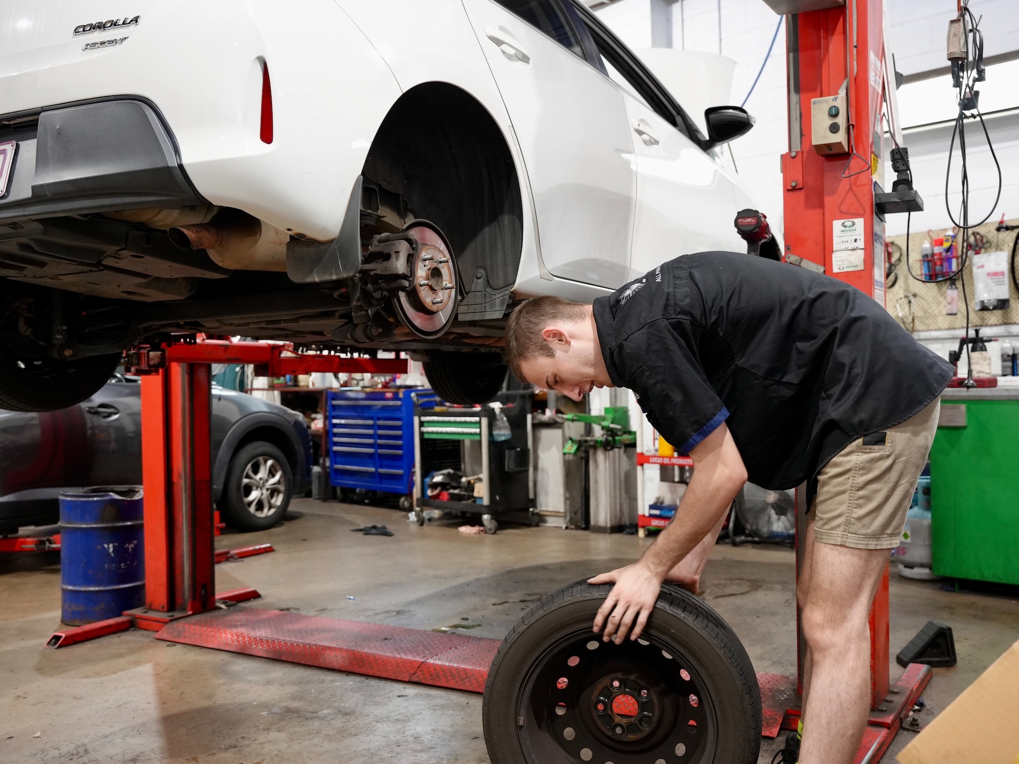Pearson Automotive mechanic fitting a new tyre and balancing the wheel on a vehicle in the Milton workshop.