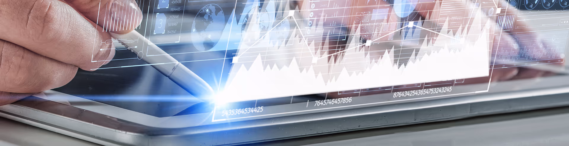 Hand using a stylus to interact with a tablet displaying digital data charts and graphs.