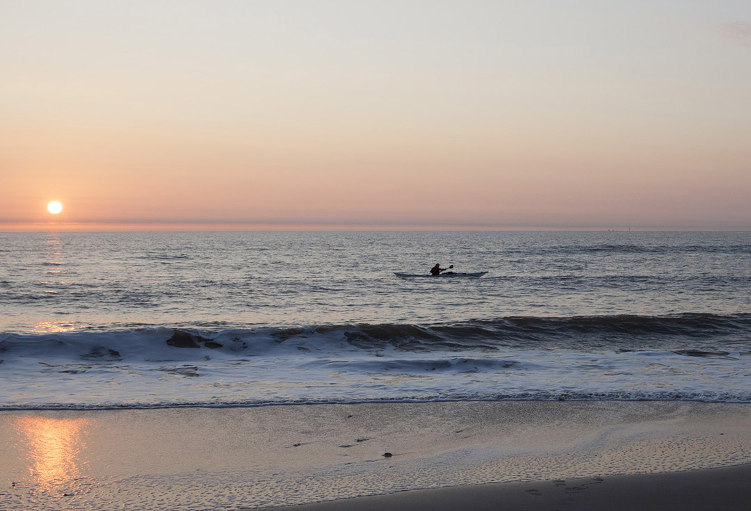 A kayak on open water at sunset