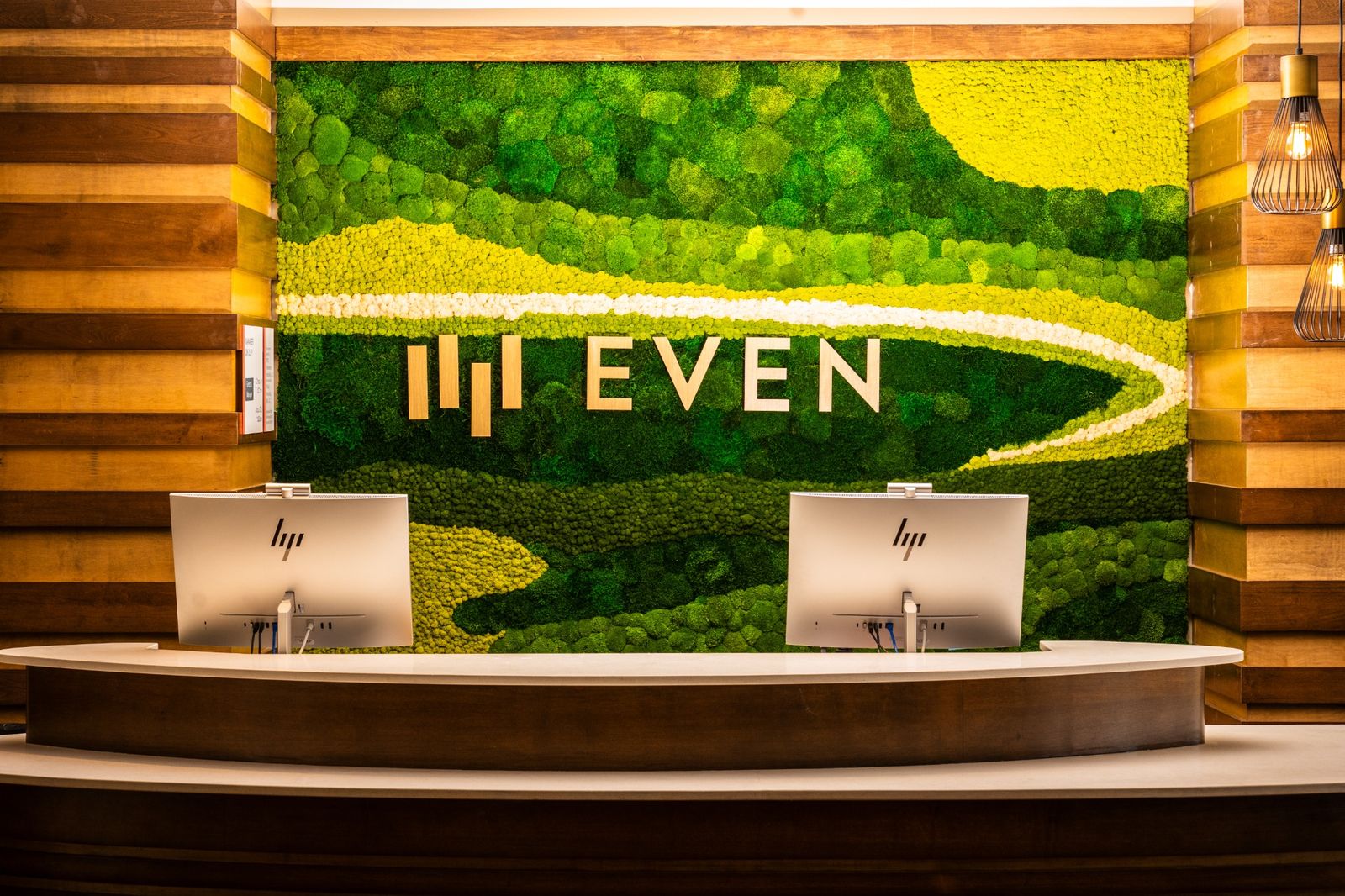 Custom preserved moss feature wall installed in a Hilton DoubleTree hotel lobby with seating area