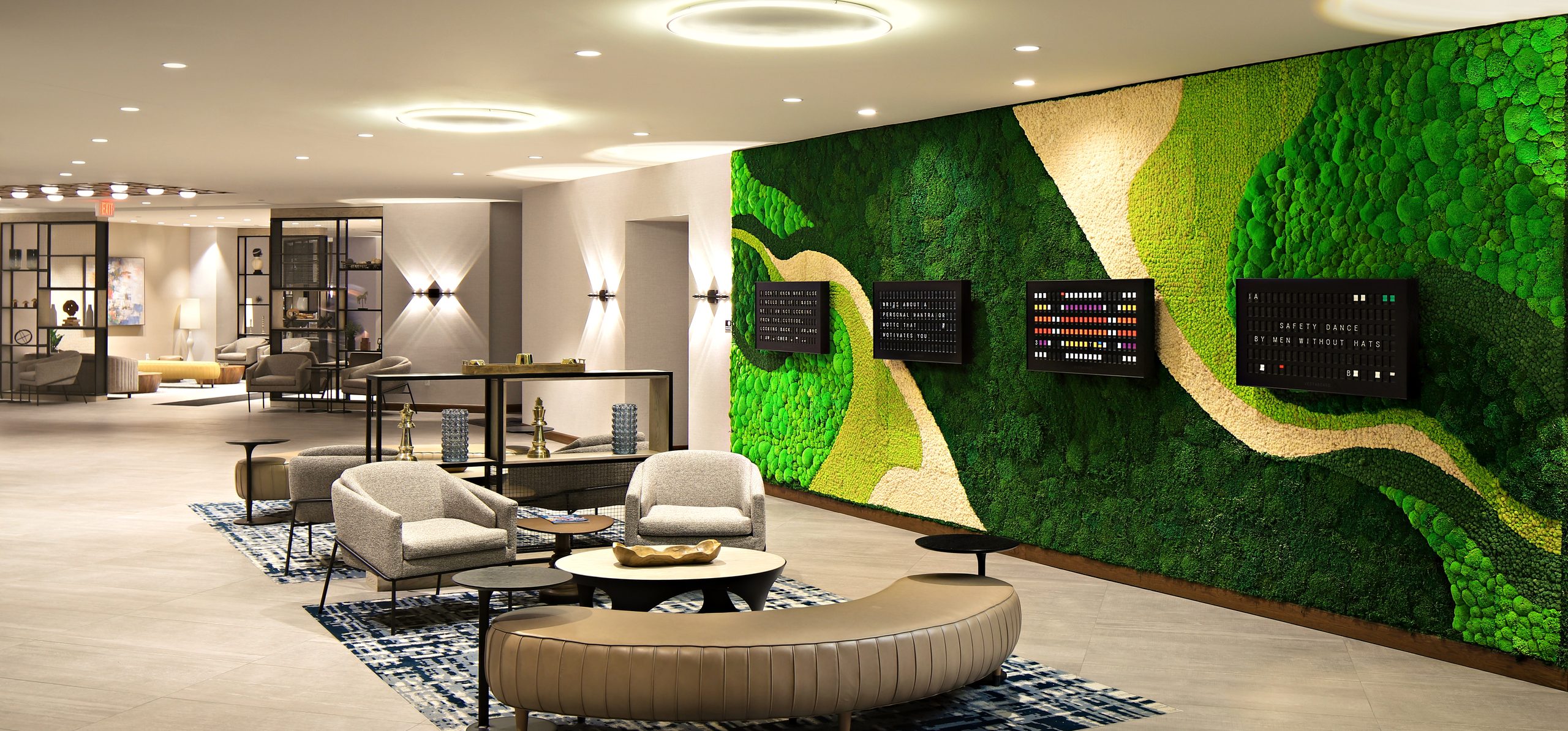 Preserved moss feature wall running the length of a commercial corridor interior