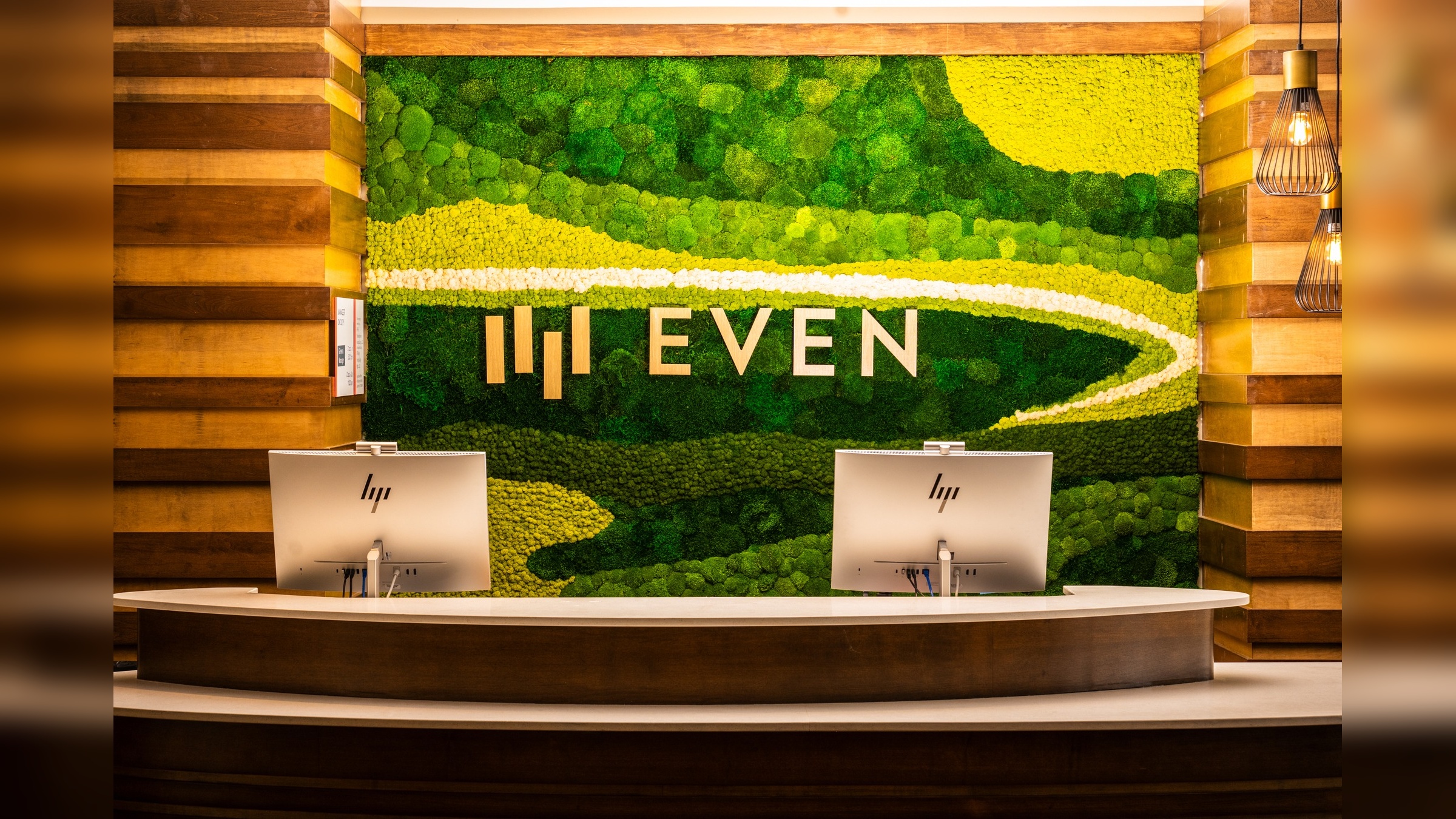 Custom preserved moss feature wall installed in a Hilton DoubleTree hotel lobby with seating area