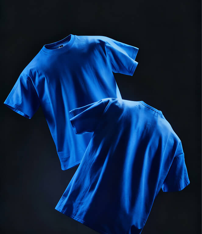 Two plain blue t-shirts displayed against a dark background, one showing the front and the other showing the back.