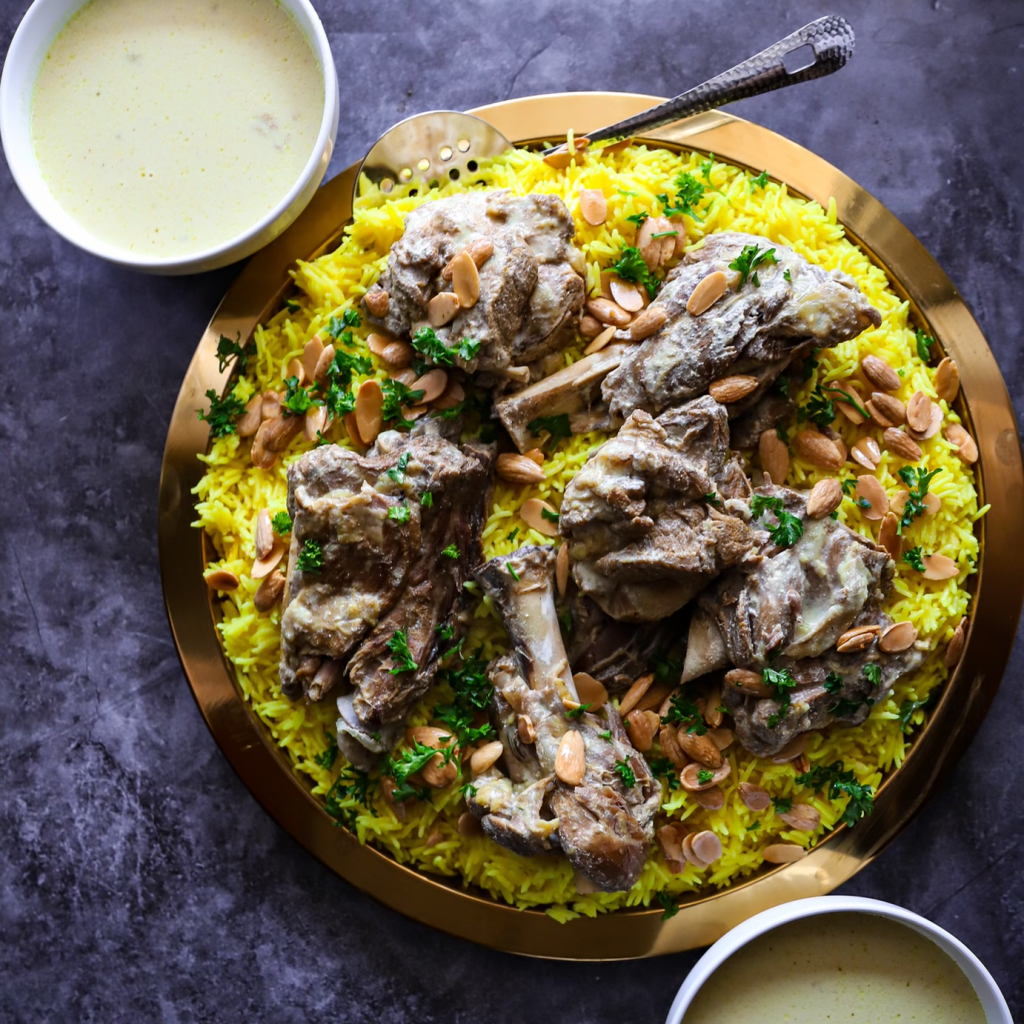 Traditional Jordanian mansaf at Dukkan International Market, lamb cooked in rich jameed yogurt sauce served over yellow rice with almonds and parsley