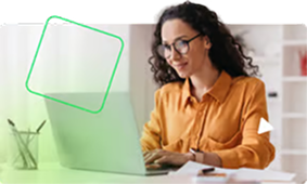 Woman pointing at a computer screen while a man watches attentively in a modern office setting.