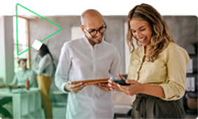 Two colleagues collaborating and discussing work in front of a computer screen in a modern office.