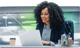 A woman and a man collaborating while looking at a computer screen in a modern office.