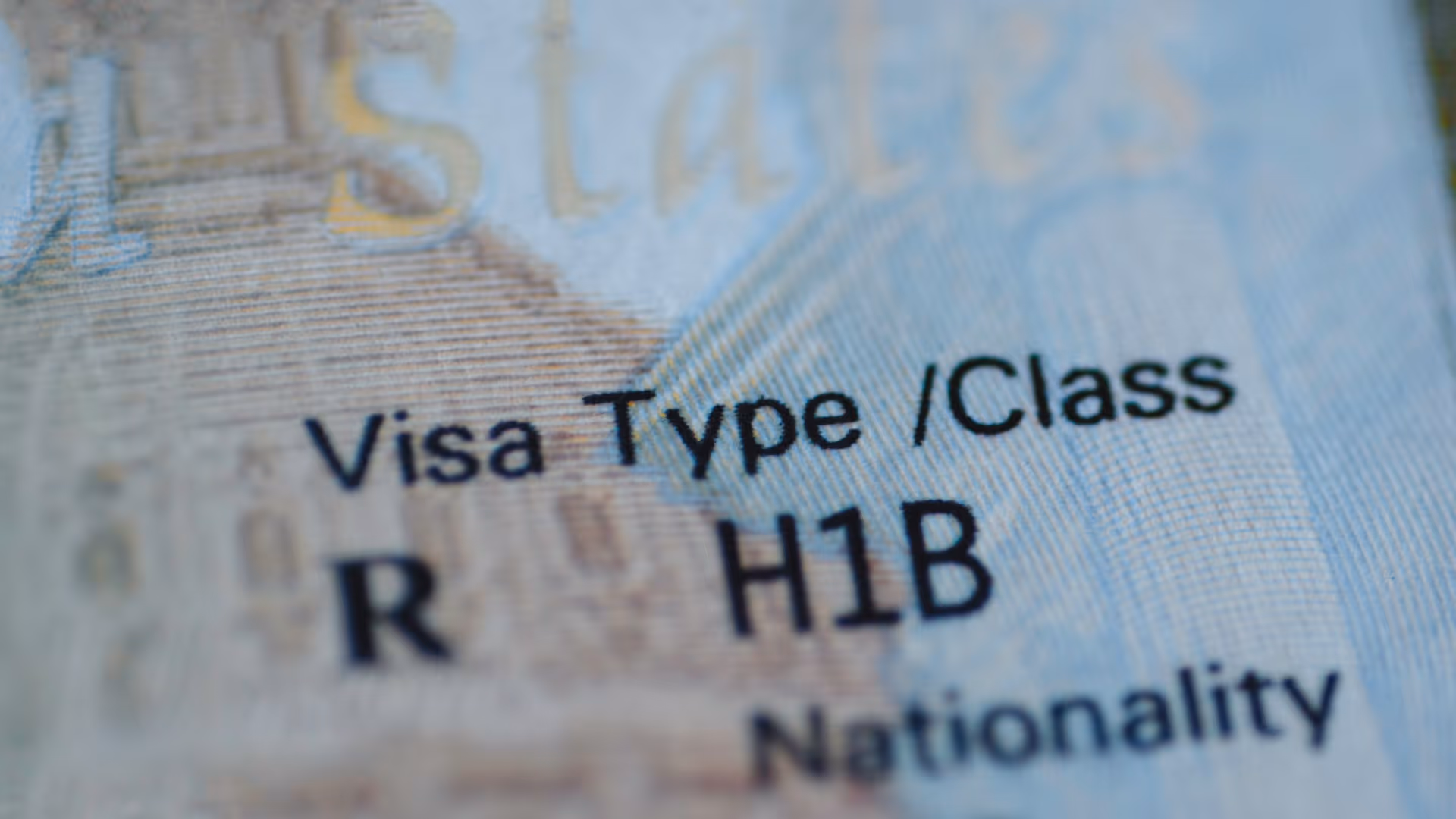 Close-up of a visa document showing the text 'Visa Type / Class R H1B' and part of the word 'Nationality'.