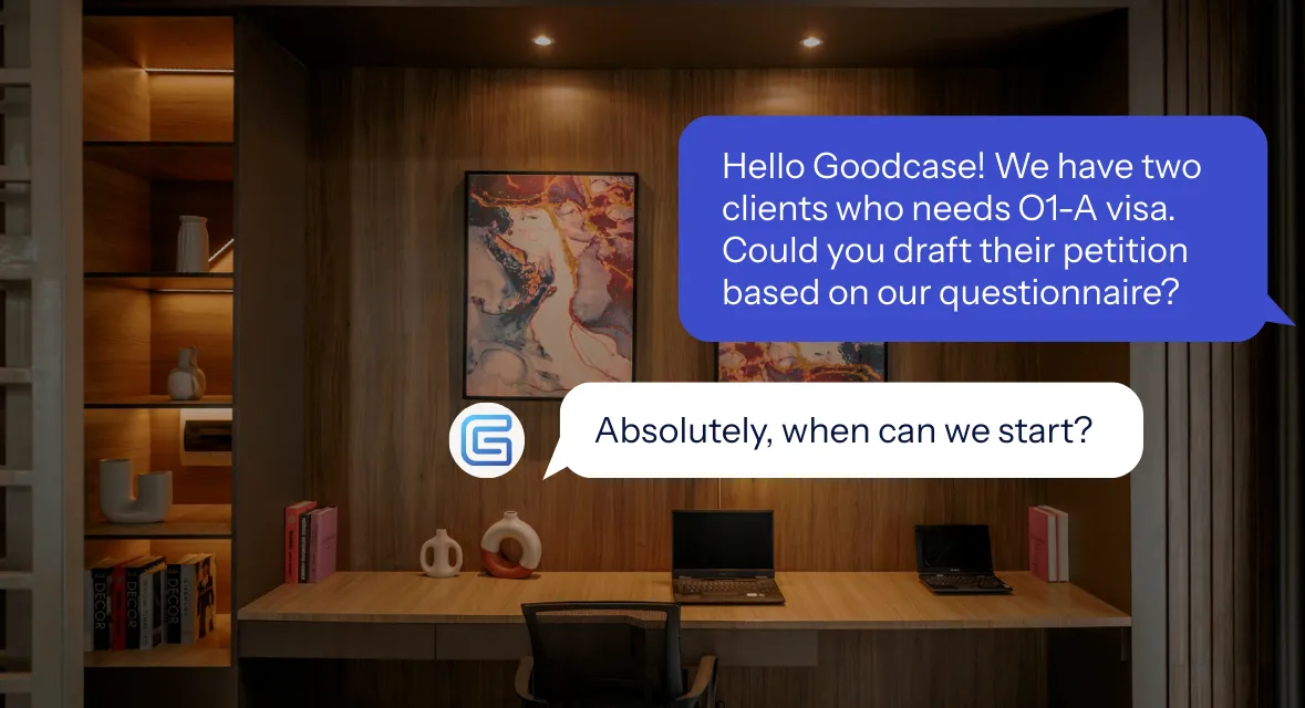 Chat conversation overlay on a modern wooden office desk with books and decorative items; message requester asks to format and polish an H-1B RFE response to USCIS standards, with a reply from GoodCase confirming they will handle it.