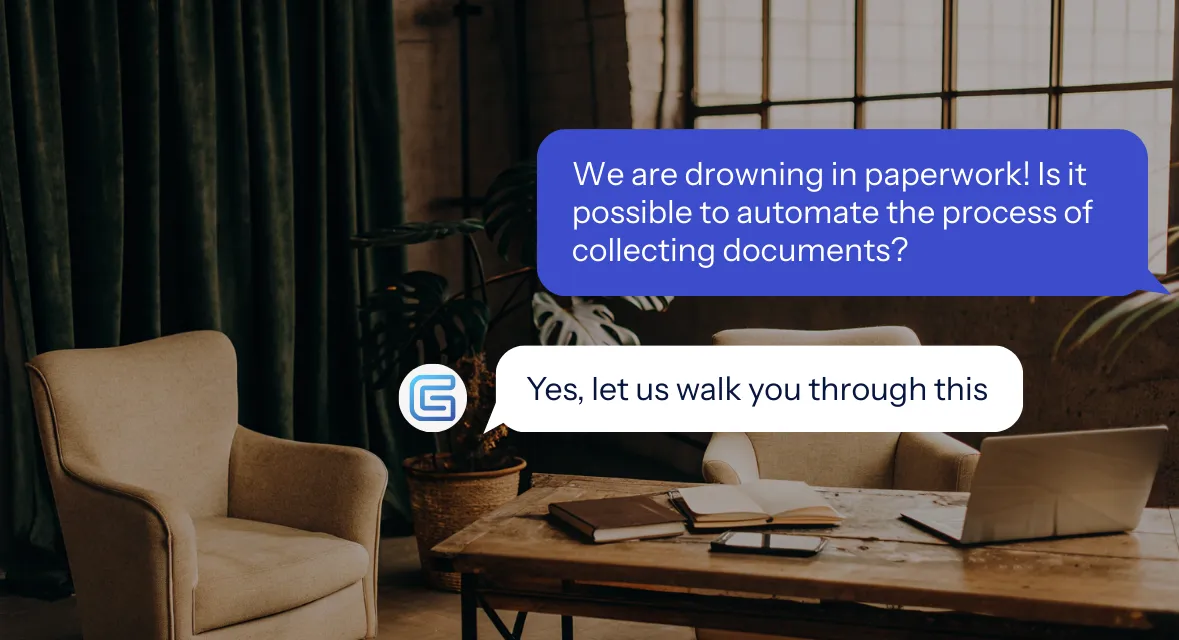 Modern office corner with beige armchair, large leafy plant in a pot on a small white table next to a desk with computer and blinds in the background.