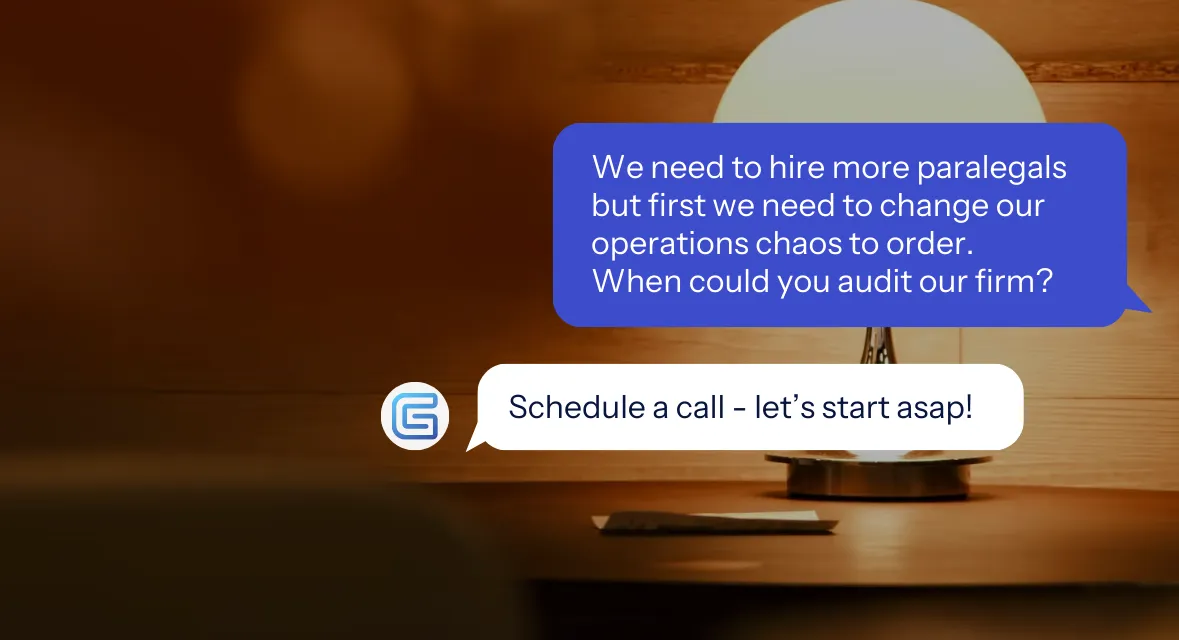 Modern table lamp with a white dome shade on a wooden desk against a wooden wall.