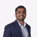 Smiling man in a suit jacket and white shirt