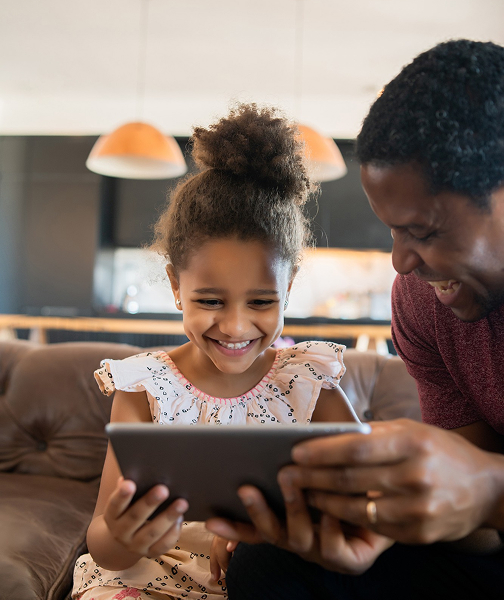 Parent teaching child financial literacy with gamified app.