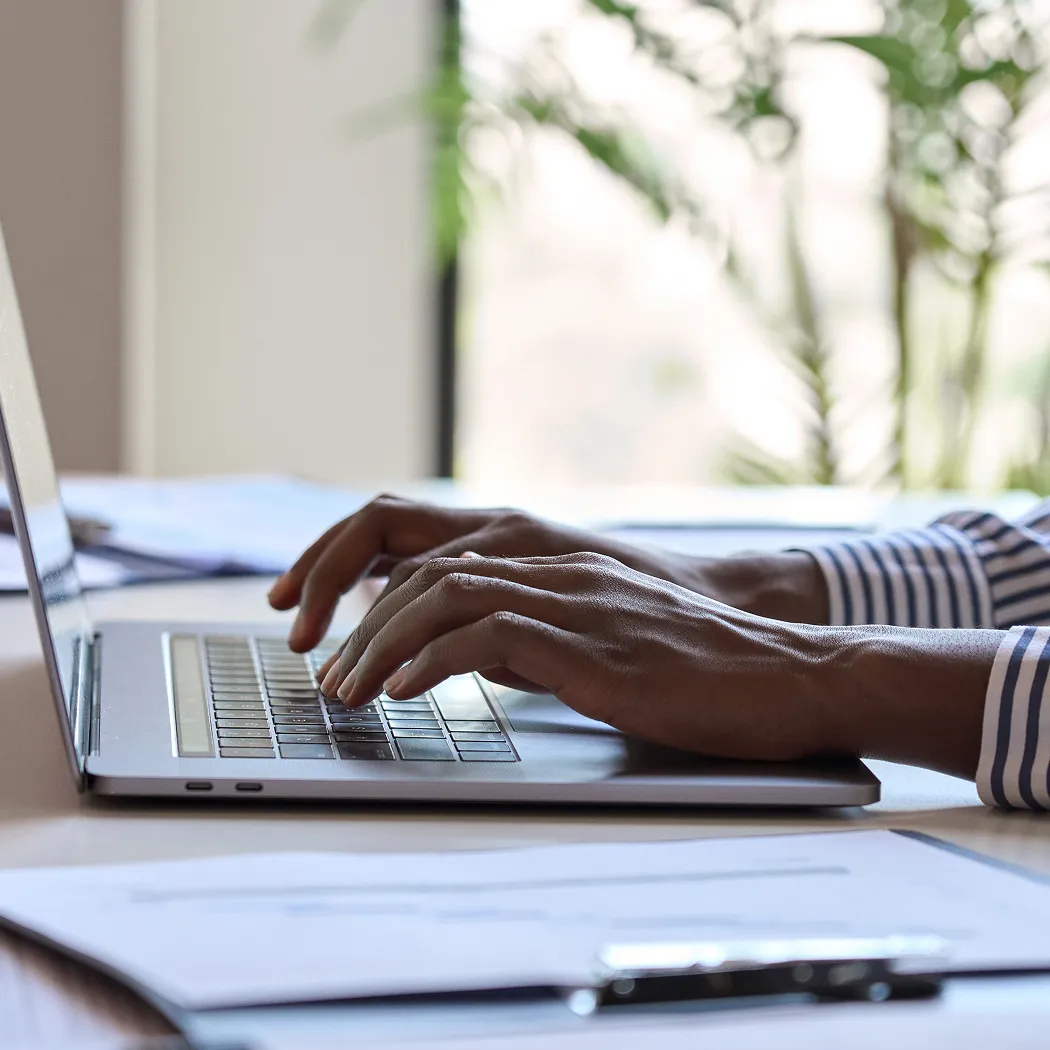 Student working on laptop with learn-to-earn app for kids.