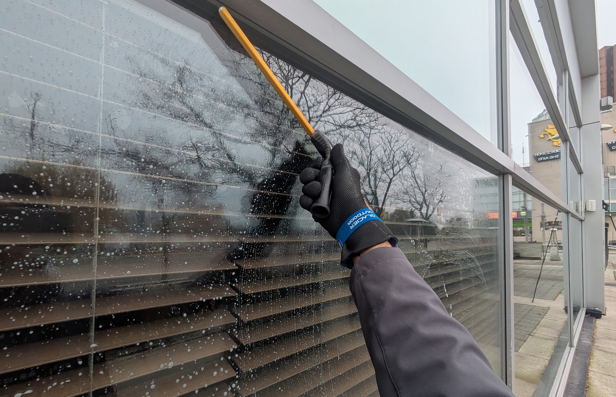 A window cleaner holding a squeegee.