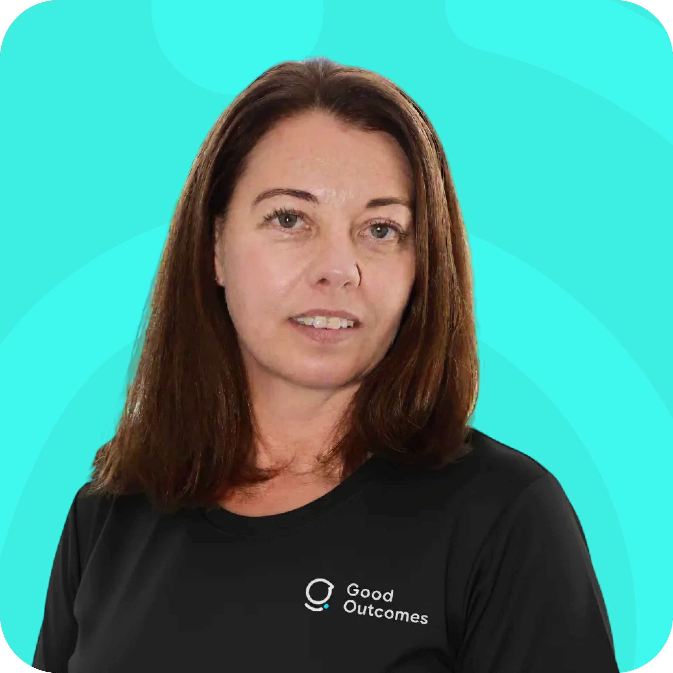Woman with shoulder-length brown hair wearing a black shirt with a Good Outcomes logo on a bright turquoise background.