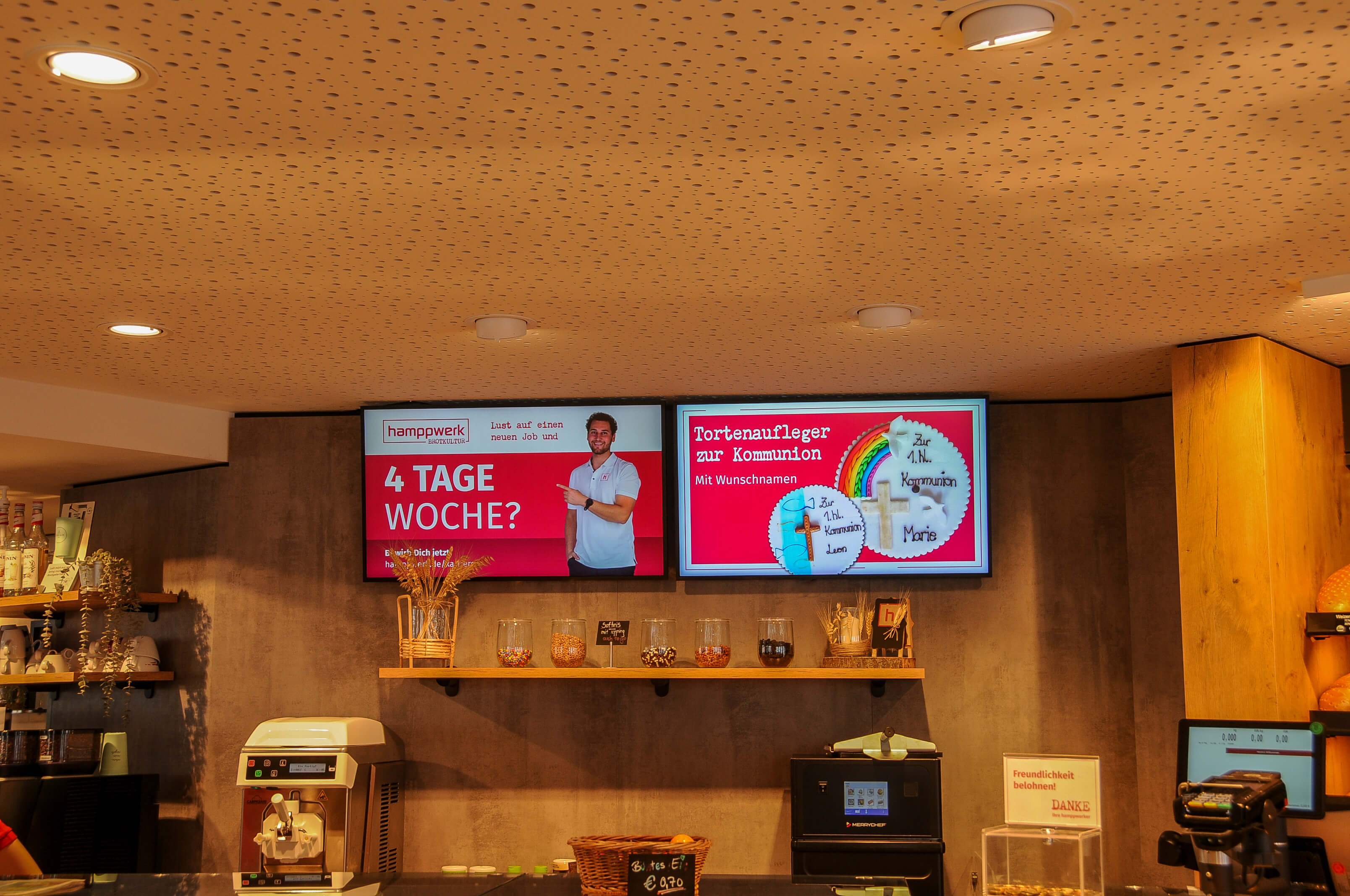 Digital menu board in a bakery branch displays current product information and job postings via connectSignage.