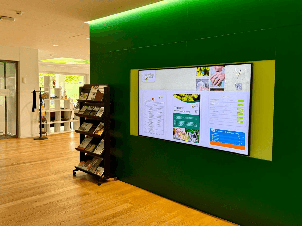 The digital signage screen at the main entrance of Kastanienpark keeps visitors, residents, and staff informed.