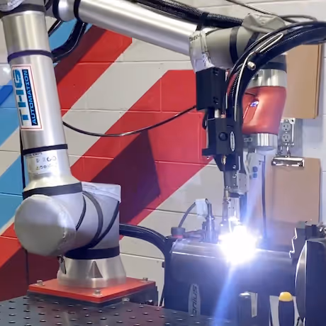 Tig welding robot in action with the part held by a positioner