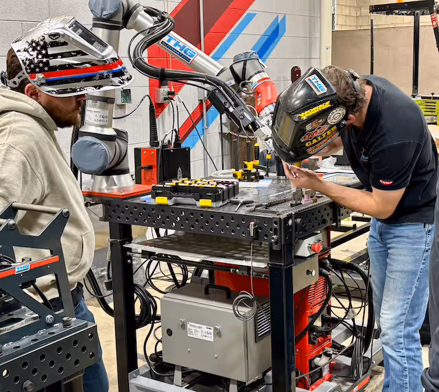 2 people programing a robotic tig welder from THG Automation